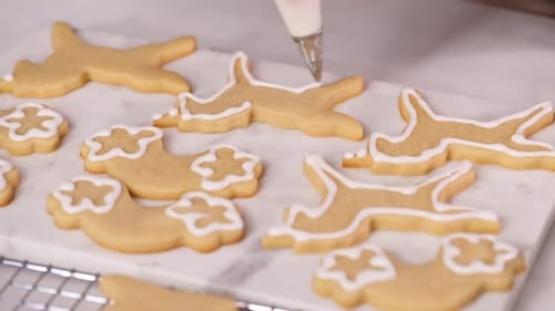 Step by step. Decorating unicorn shaped sugar cookies with royal icing for little girl birthday part
