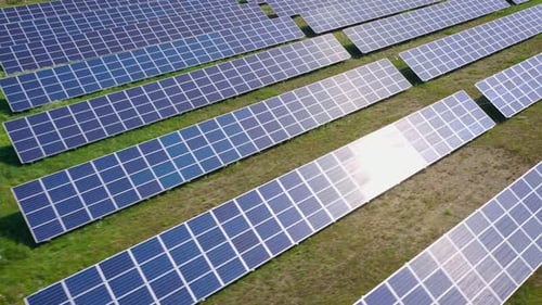 Flight Over a Field of Solar Panels in Sunny Summer Day