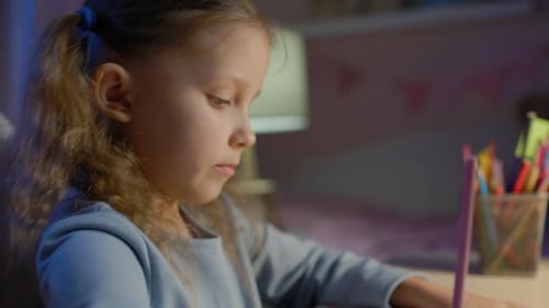 Schoolgirl Junior School Does Homework In The Evening