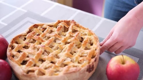 Apple Pice Cake Preparation Series Woman Slicing Pie on a Table Top View