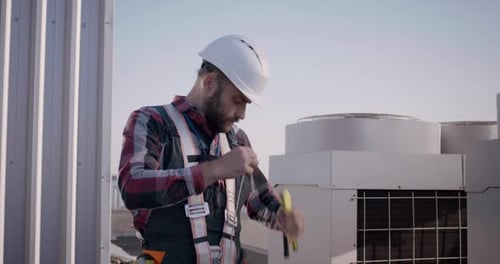 Engineer Rolling Up Cable