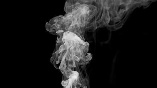 White Smoke Billowing Against Black Background