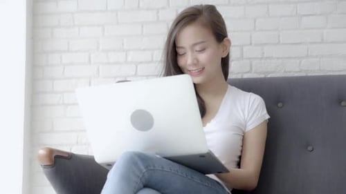 Young Woman Working on Laptop at Home
