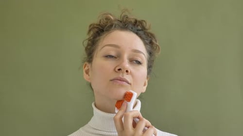 Woman Using Facial Roller Beauty Treatment Close Up
