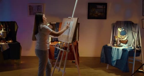 Artist Works in the Studio Draws a Picture with Paints