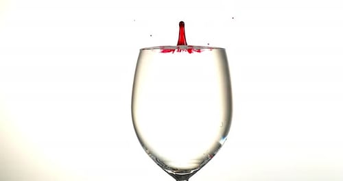 Red Ink falling into Liquid against White Background, Slow motion 4K