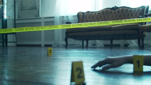 Hand at Crime Scene with Evidence Markers