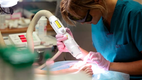 Woman Receiving Laser Treatment on Her Feet