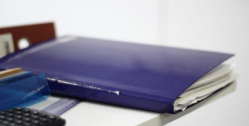 Blue Book and Stationery Items Close Up