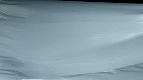 White Fabric Rippling Gently in an Abstract Motion