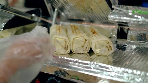 Cook Warms the Cooked Shawarma on the Grill