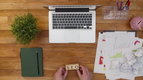 SEO abbreviation made up of wooden cubes on an office table. Search engine optimization concept.