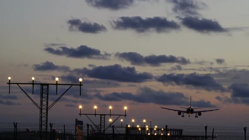Commercial Airplane Landing at Sunset