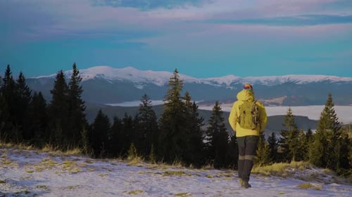Lone Hiker Exploring Snowy Mountain Wilderness