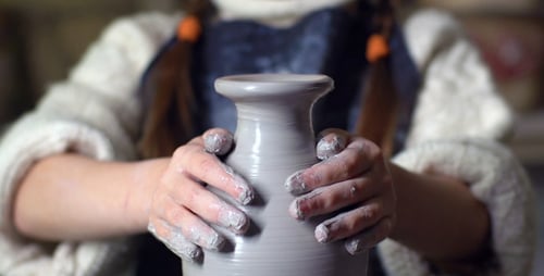 Young Girl Creating Pottery Vase in Studio