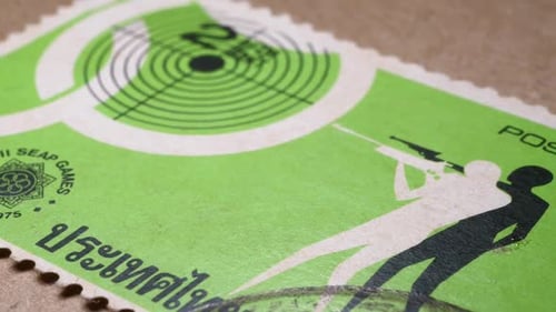 Thailand Postage Stamp Featuring Shooter on Brown Paper