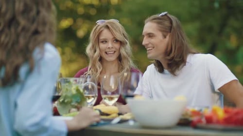 Friends Having Fun Picnic Outside on Summer Day