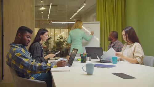 Diverse Team Engaged in Dynamic Office Meeting