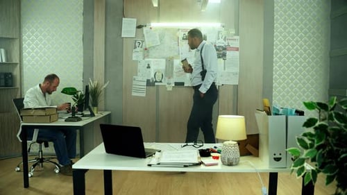 Men Working in Office Discussing Investigation