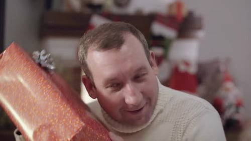 Man Receives Christmas Gift and Smiles Happily