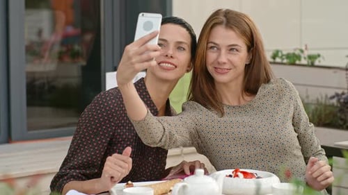 Happy Women Friends Taking a Selfie at Tea