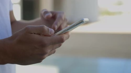 Close Up of Hands Using Smartphone Outdoors