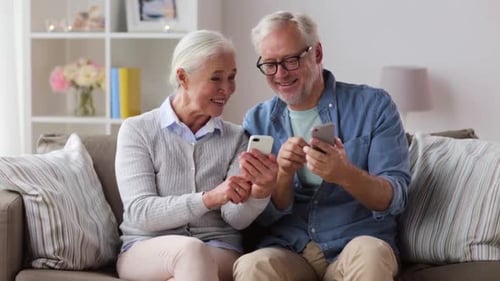 Senior Couple Relaxing Together with Smart Phones