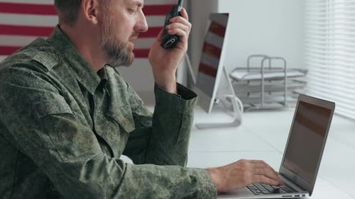 Army Officer in Uniform Using Walkie-Talkie in Office