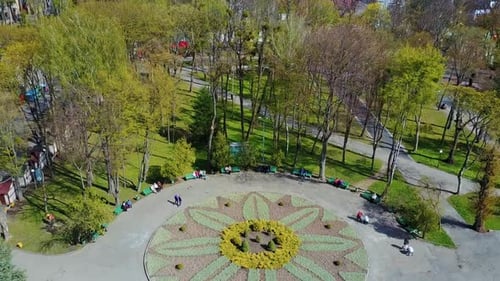 Beautiful park in the city center. Natural view of a park with people walking. Urban background with