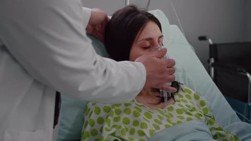 Close Up of Medical Doctor Putting Oxigen Mask to Sick Woman
