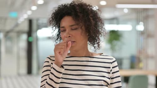 Woman Coughing in Office Setting