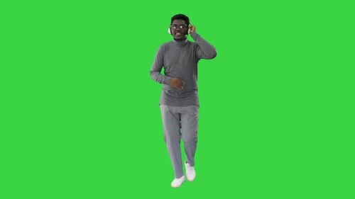 Young Adult Dancing with Headphones on Green Screen