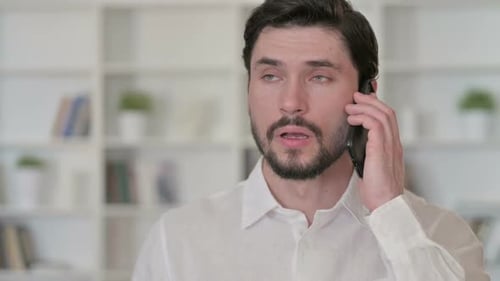 Close Up of Man Talking on Smartphone