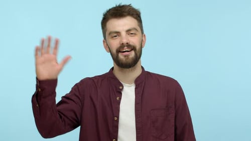 Man Smiling and Waving Hello on Blue Background