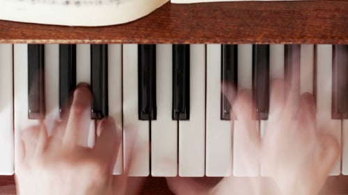 Hands Playing Piano in a Close Up Shot