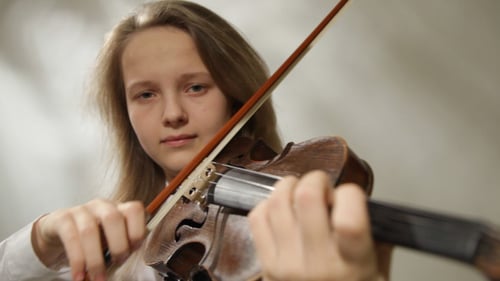 Teen Girl Plays Violin With Passion