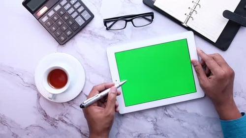 High Angle View of Man's Hand Working on Digital Tablet at Office Desk,