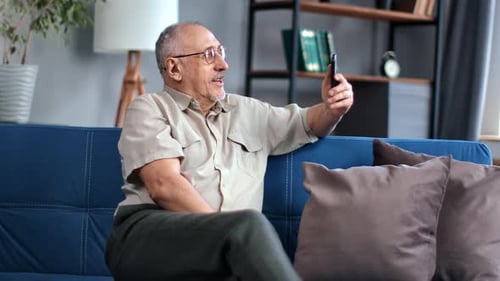 Adult Video Call on Mobile Phone From Couch