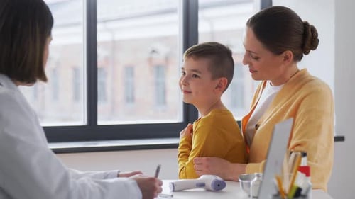 Mother with Little Son and Doctor at Clinic
