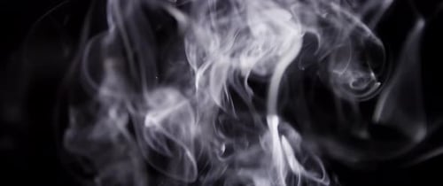 Elegant White Smoke Swirls Against Black Background