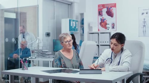 Doctor Consults With Mature Woman in Office