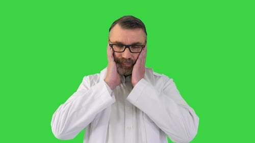 Tired Depressed Old Male Doctor on a Green Screen Chroma Key