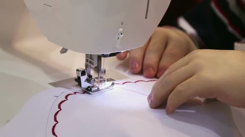 Close Up of Sewing Machine Stitching Red Pattern