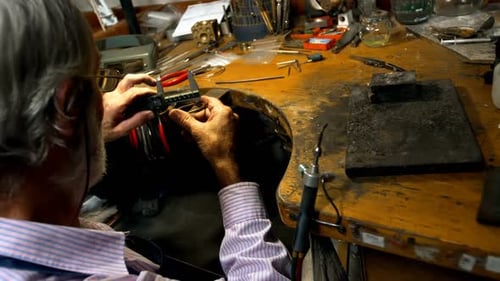 Goldsmith manufacturing jewellery in workshop