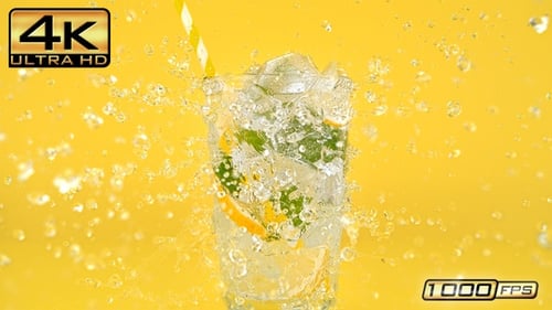 Refreshing drink with ice and splashing water