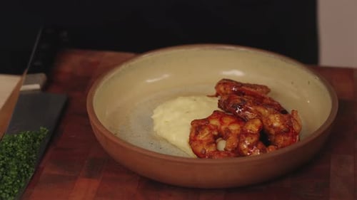 Chef Arranges Shrimp on Mashed Potatoes for Elegant Meal
