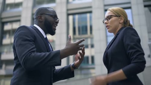 Business Colleagues Arguing Outside Office Building