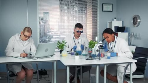 Mixed Race Team of Research Scientists Working in Modern Bright Chemistry Lab