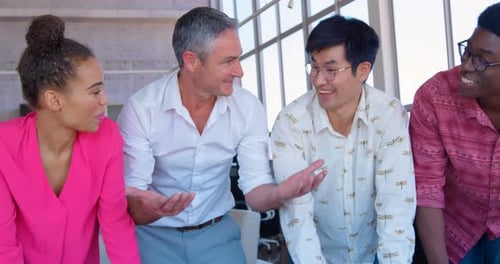 Multi-ethnic business colleagues interacting with each other in office 4k