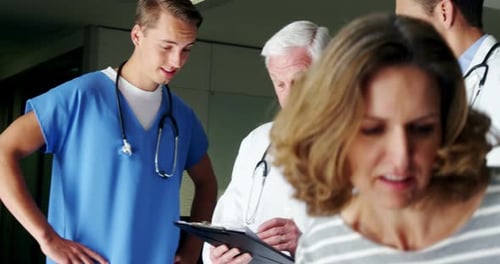 Doctors Consult with Patient and Child in Hospital